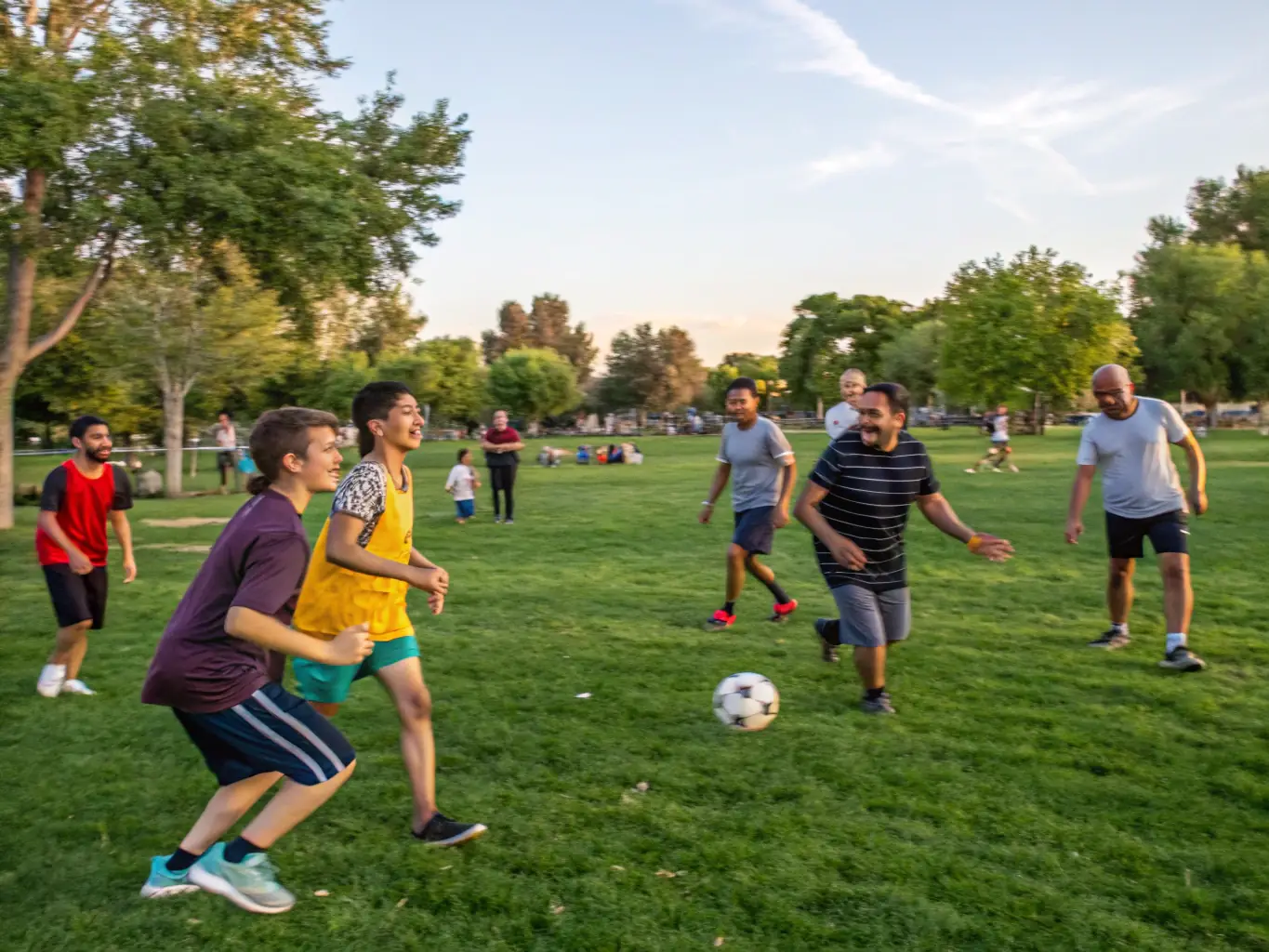 A diverse group of community members participating in a sports event, highlighting the inclusive and supportive environment fostered by the sports association.